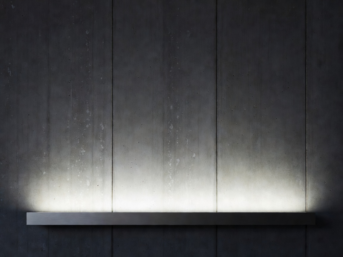 Linear wall grazing fixture casting gradient beam on concrete facade